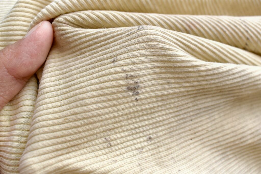 Dirty clothes with engine oil stain on it. Oil or grease stain on clothes.