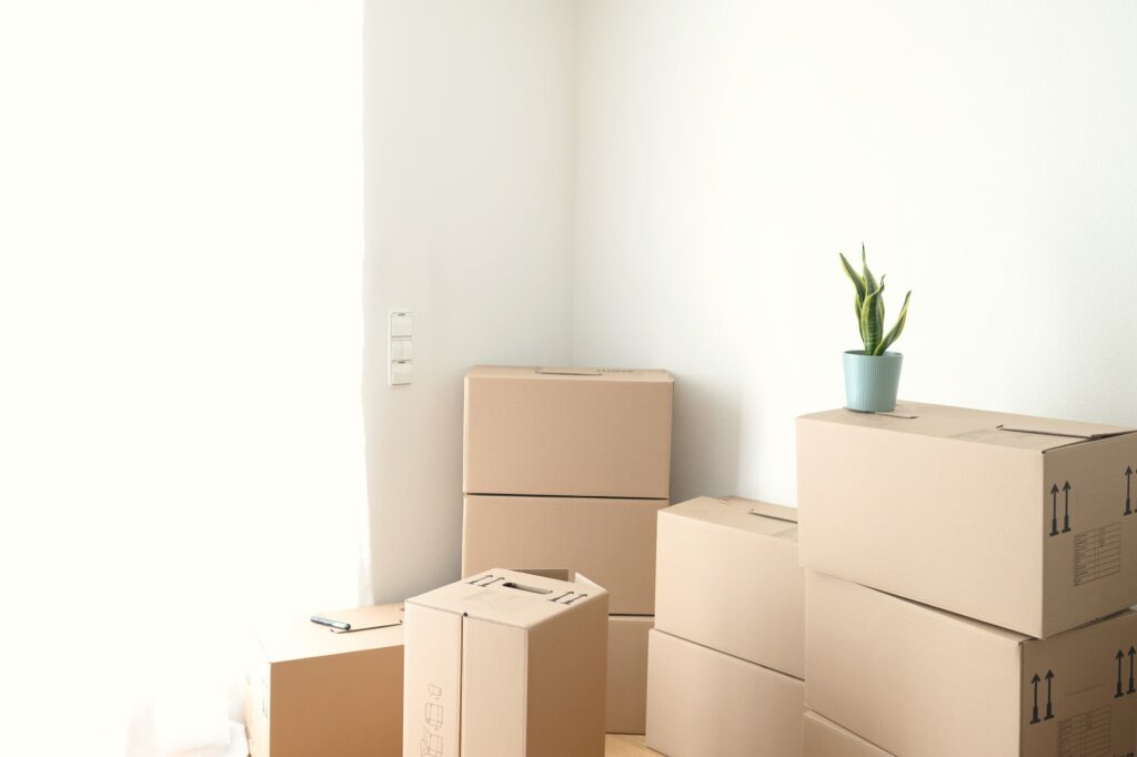 Room with stucked carton boxes. Moving to new apartment