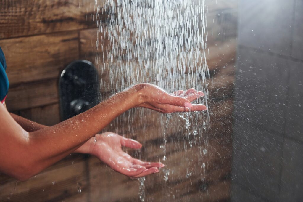 Close up view of hands of woman that taking a shower in spa