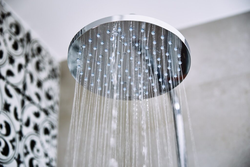 Water flowing from shower head in bathroom